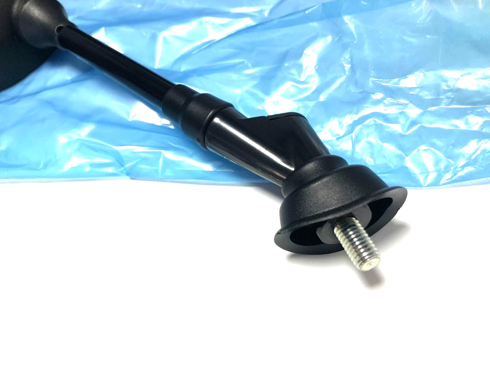 Black metal tube with threaded end, resting on blue plastic packaging, labeled “nos Sym CITYCOM 300 RH Mirror 88110-LEA-000.”